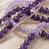 Strands of faceted and smooth round beads in assorted sizes illustrating how bead size affects the number of beads per inch.