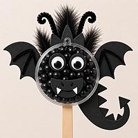 Bat fillable ornament half craft idea featuring black candies, foam wings, and spooky Halloween decorations for kids' crafts.