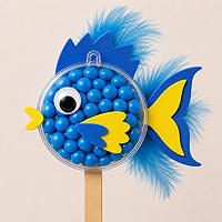 Tropical fish fillable ornament half craft project using blue candies and feathers for ocean and summer craft ideas.
