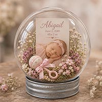Newborn baby keepsake ornament with photograph, birth information, and floral embellishments for baby shower and nursery decorating ideas.