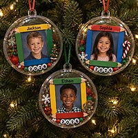 Personalized school picture Christmas ornaments featuring children's photographs and graduation year for family keepsakes.